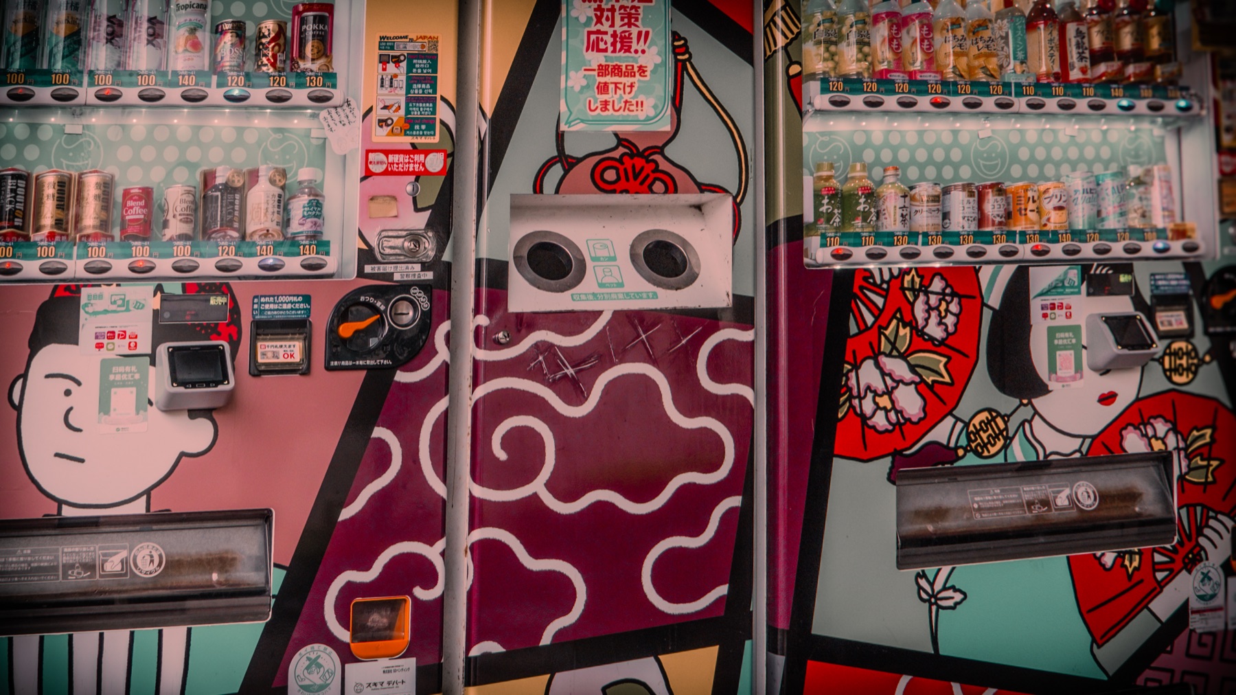 A row of illustrated vending machines and drink displays in Japan.