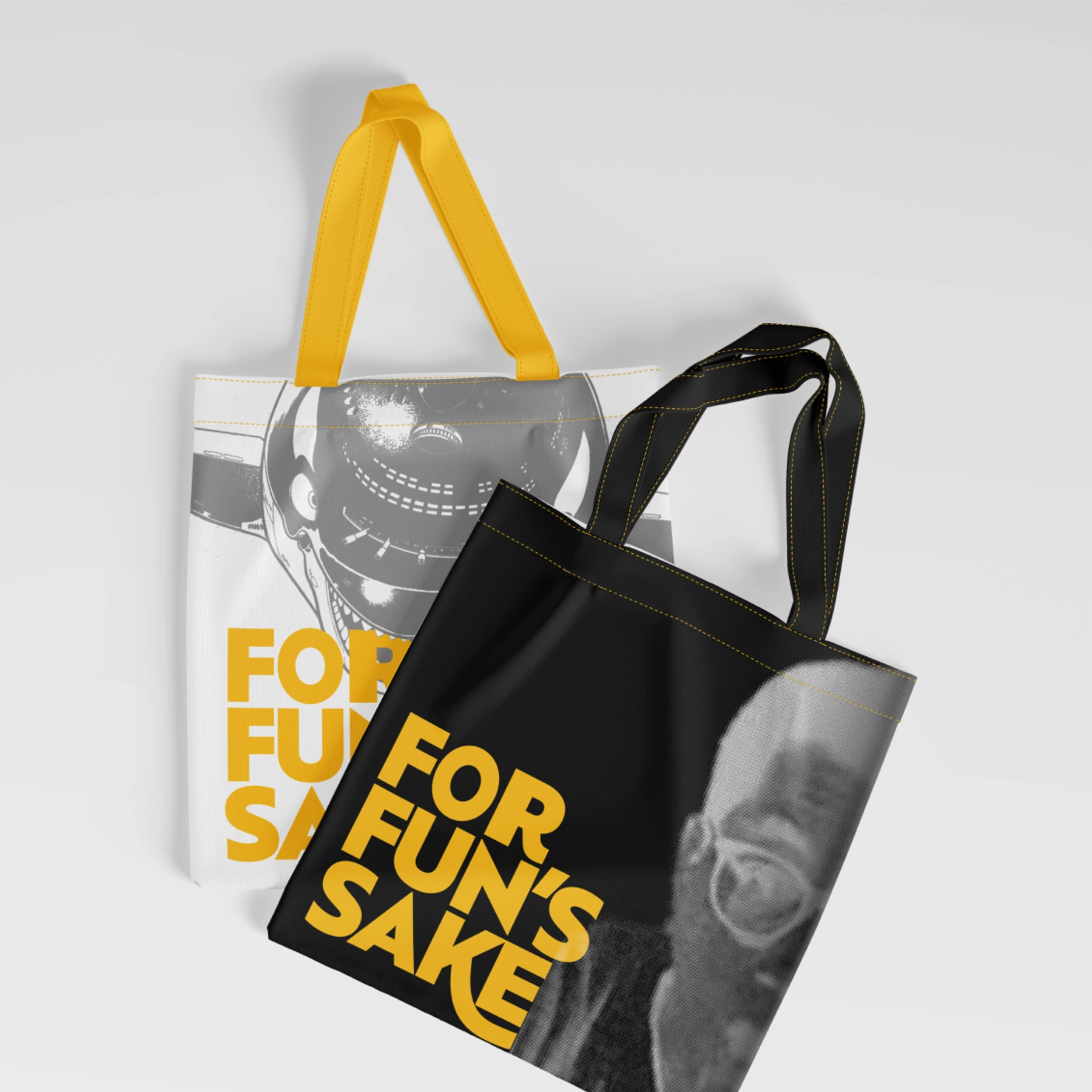 White and black For Fun's Sake tote bags with yellow handles.