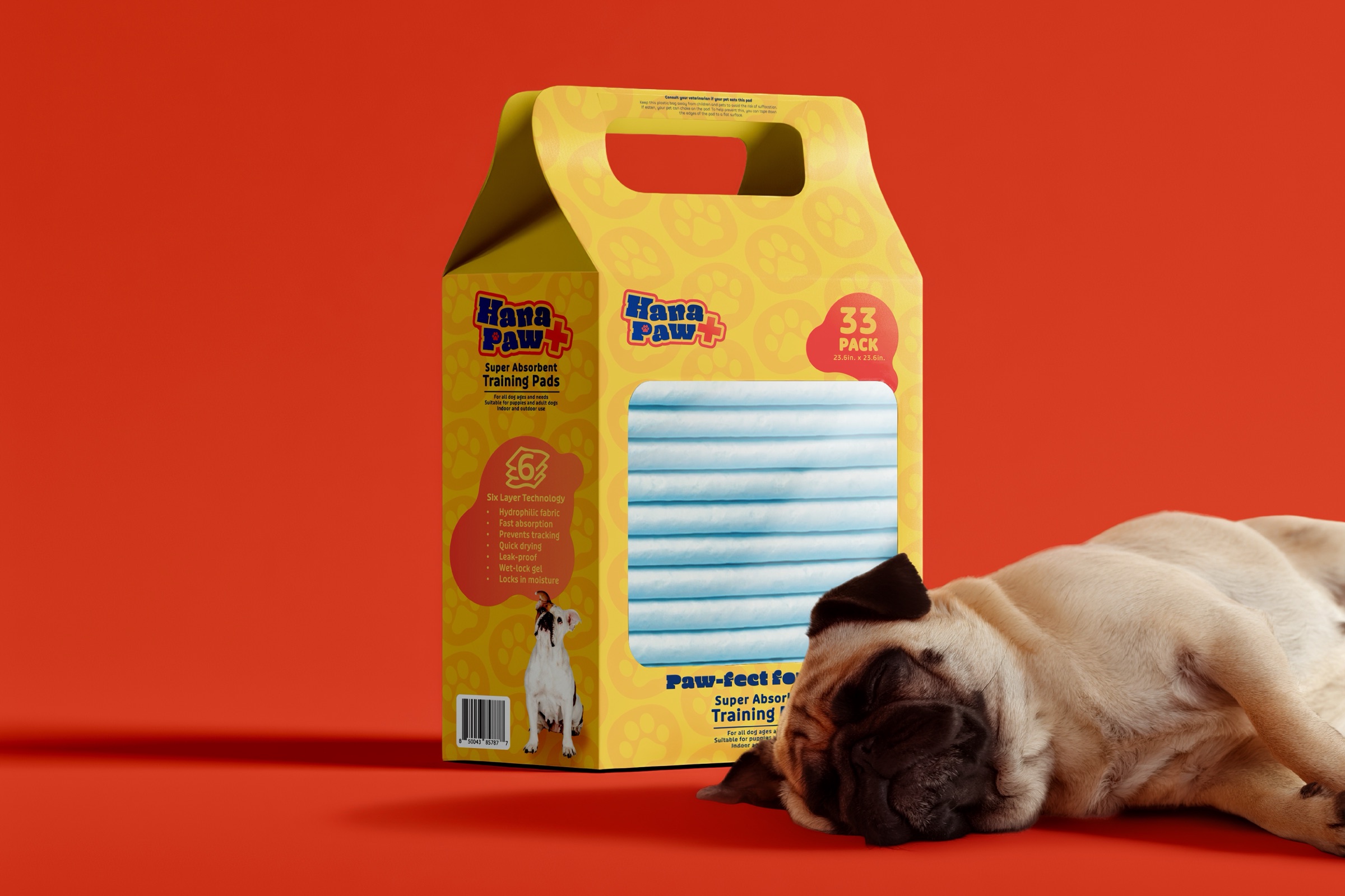 Hana Paw training pad package beside a resting dog on an orange studio background.