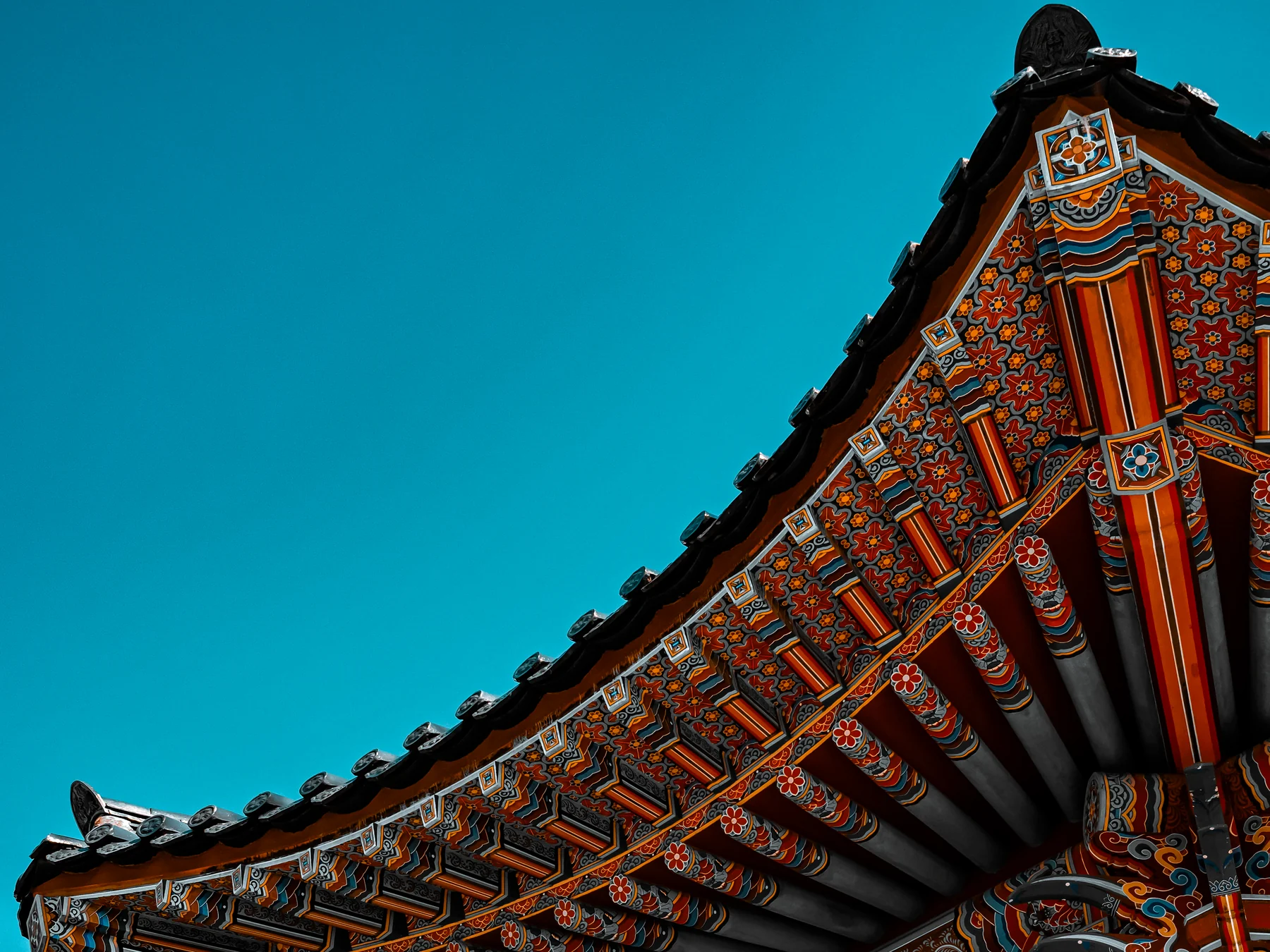 An ornate pavilion roof set against a saturated blue sky.