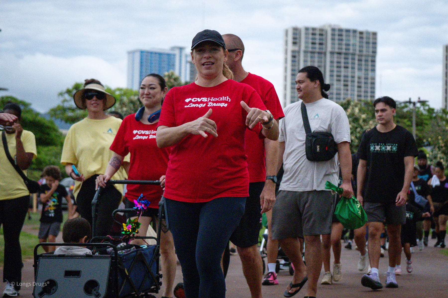 A group of participants walking through a park during a community event.