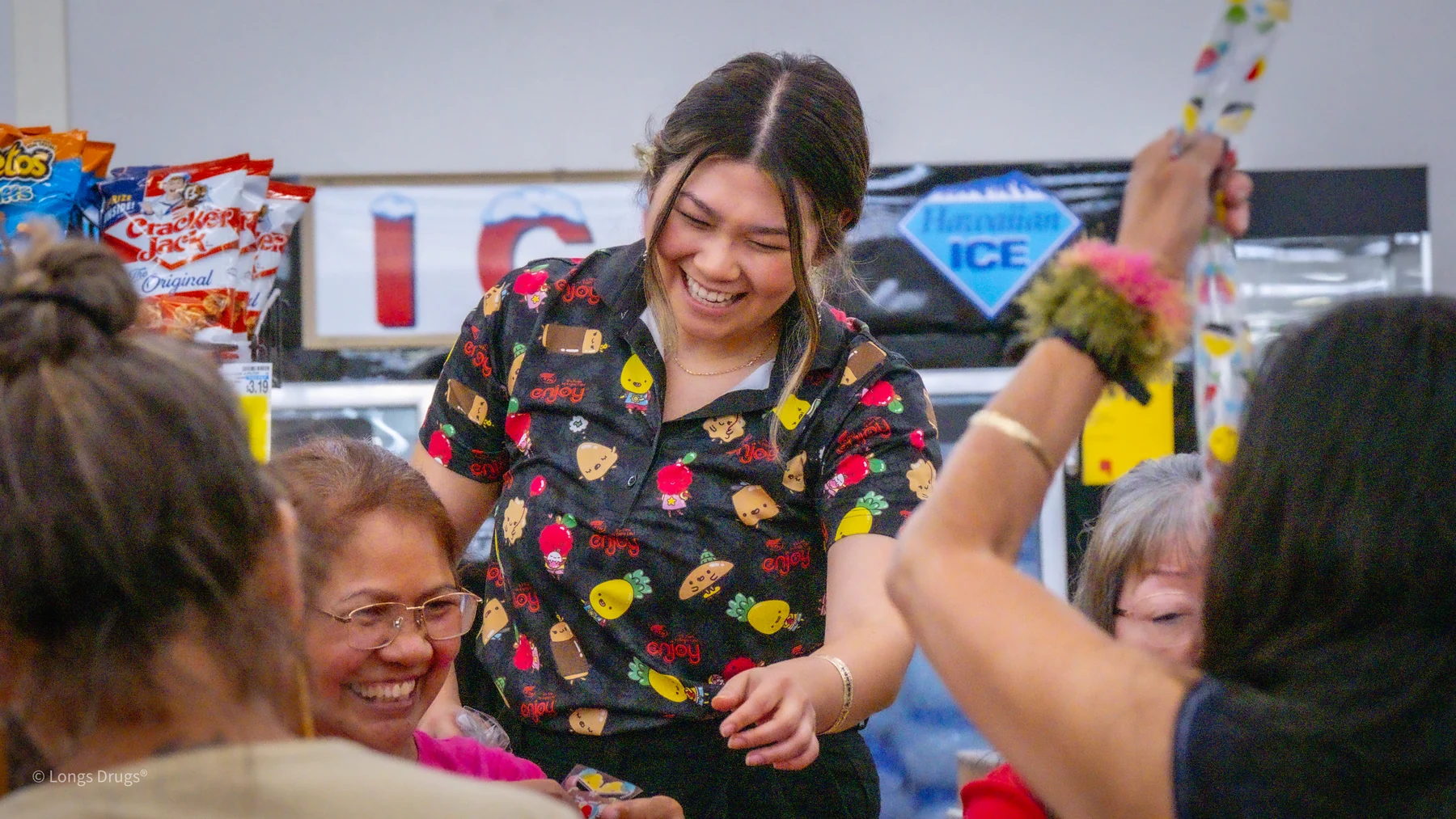 A smiling host interacting with participants around a craft table.
