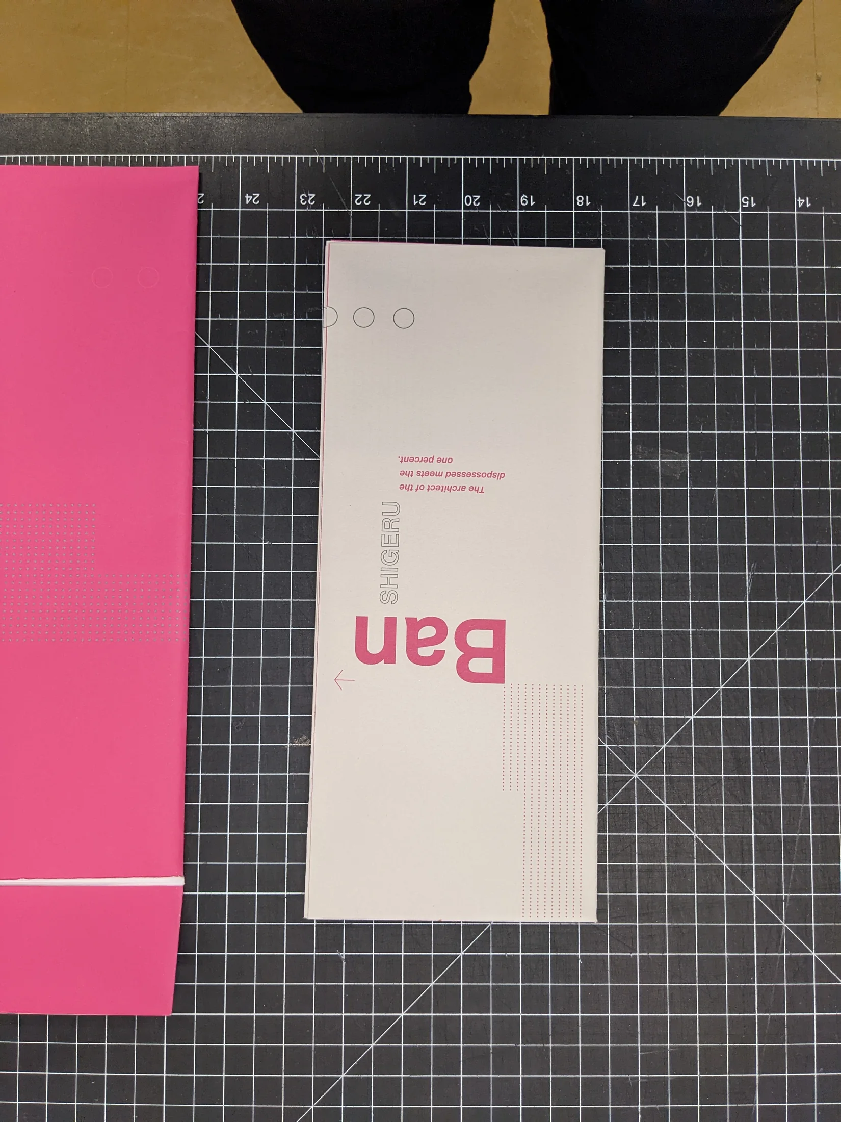 Folded Paper Palaces booklet on a gridded cutting mat.