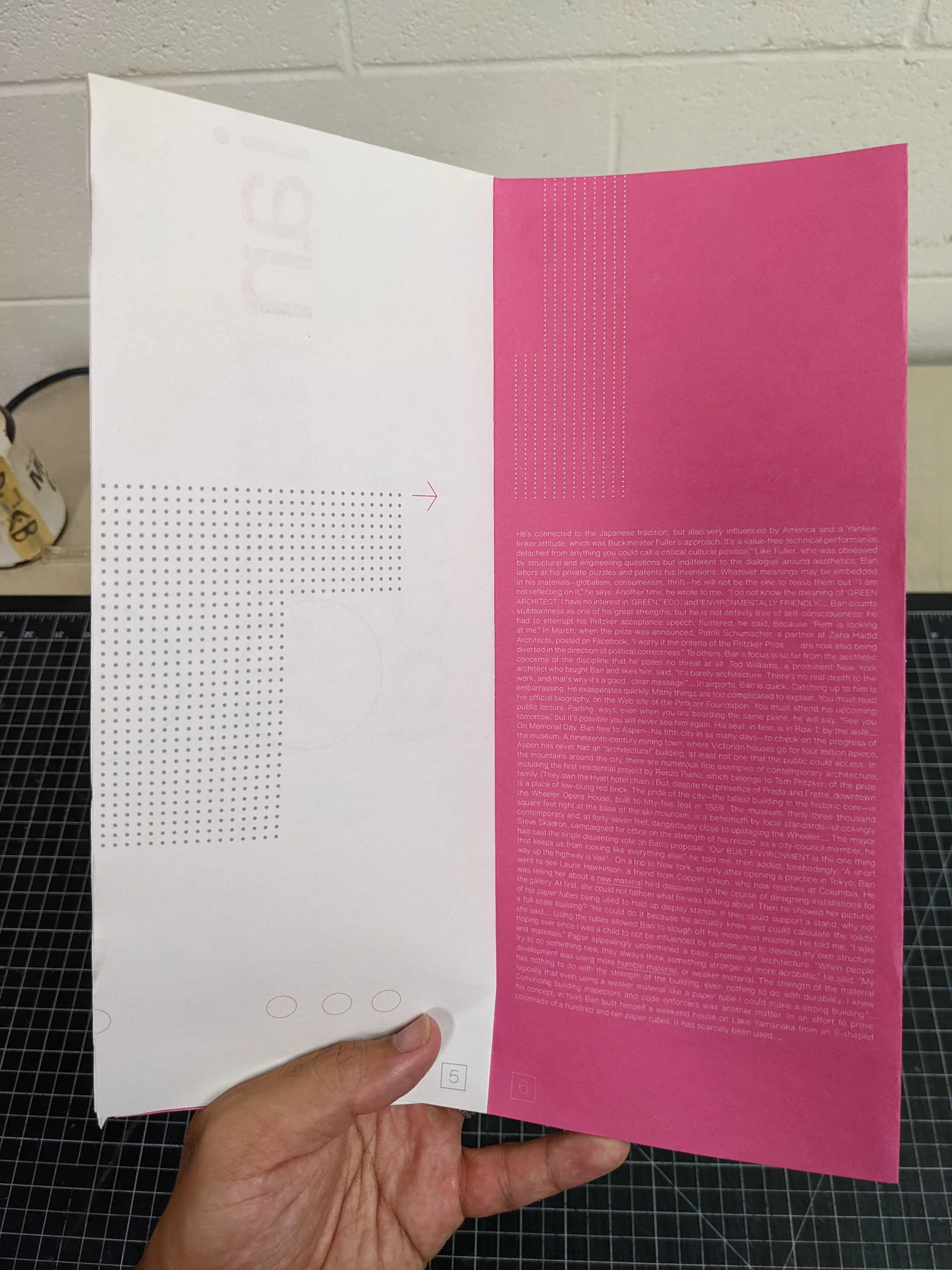 Open Paper Palaces booklet held by hand.